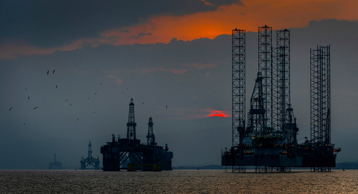 Offshore oil platforms at sunset